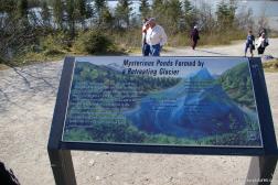 Mysterious Ponds formed by a retreating glacier sign at the Mendenhall Glacier visitor area.jpg