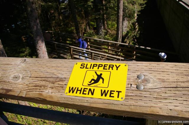 Slippery when wet sign in Juneau Homestead Park.jpg